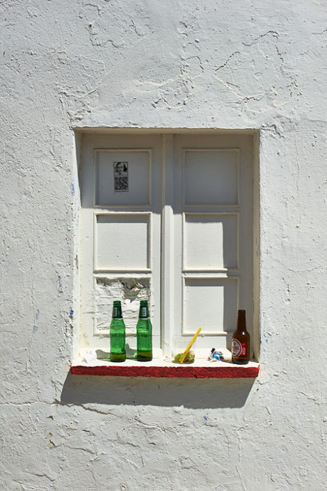 Bierflaschen vor einem zugemauerten Fenster in der Sonne