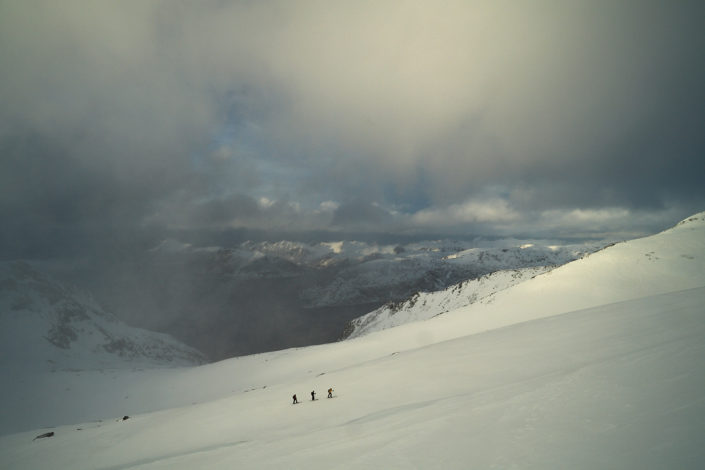 Skitourengänger kämpfen im Aufstieg gegen die heftigen Windböen