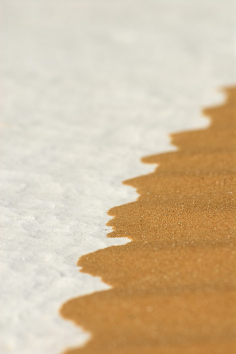 Weisser Wüstenboden wird von Sand überlagert
